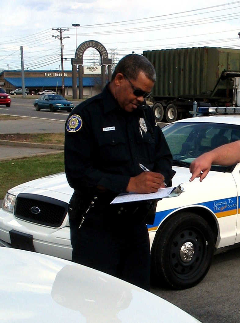 A Clarksville, TN Police officer takes a accident report ...