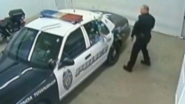 Woman Kicks Out Police Cruiser Window Video